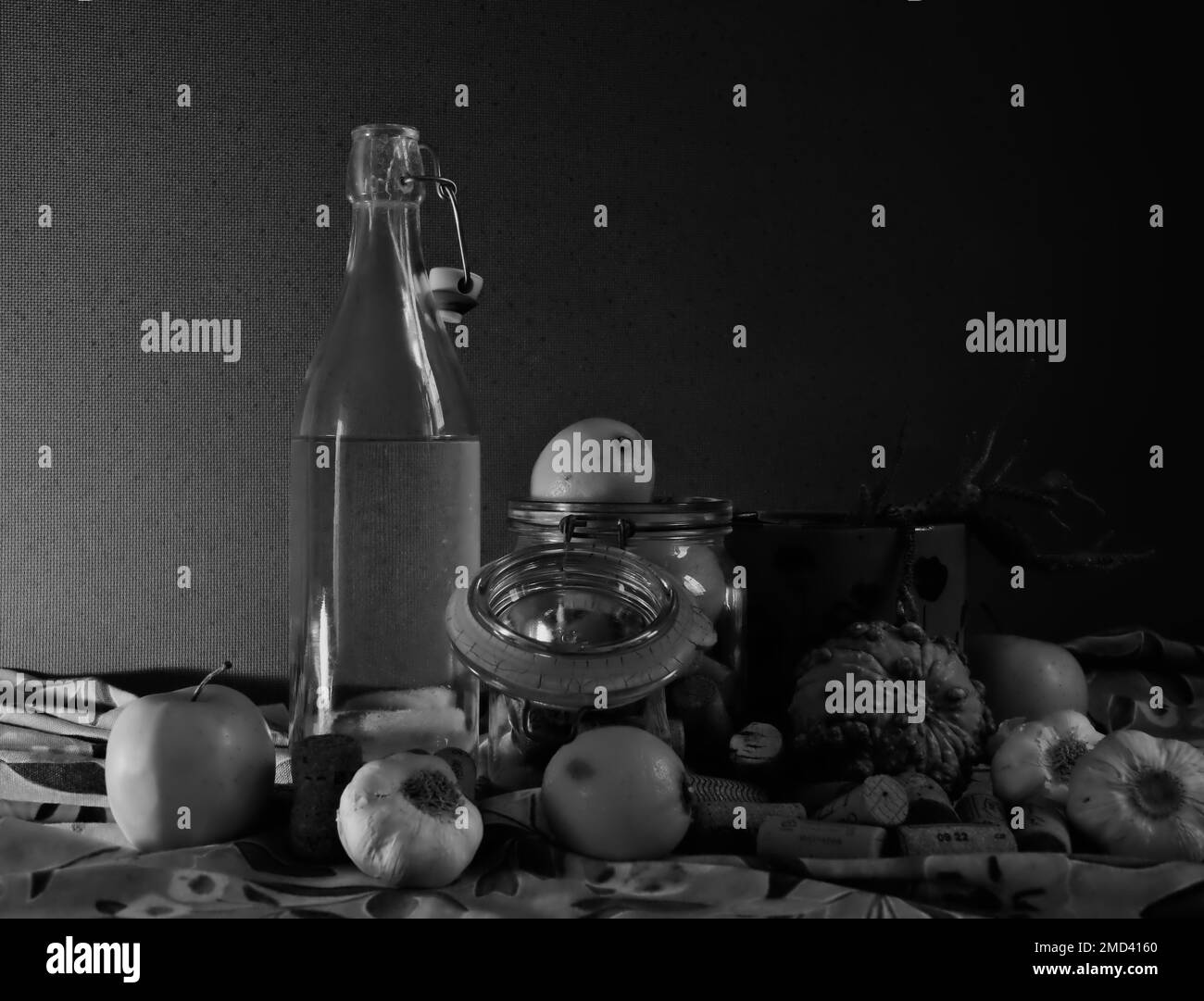 Still life with bottle, garlic and lemons. In Black and White Stock Photo
