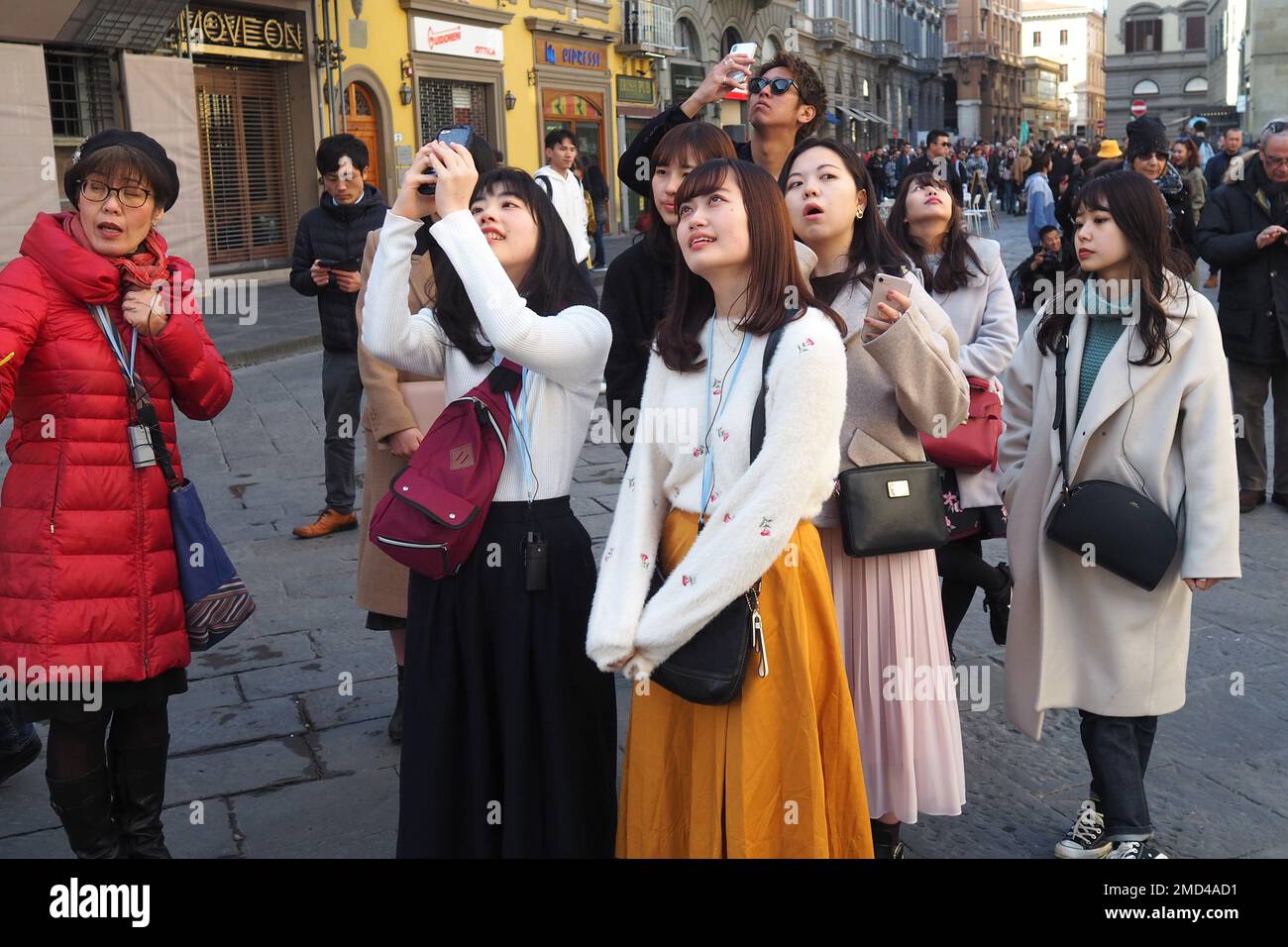 group of asian tourists taking picture in a street of Florence, Italy Stock Photo