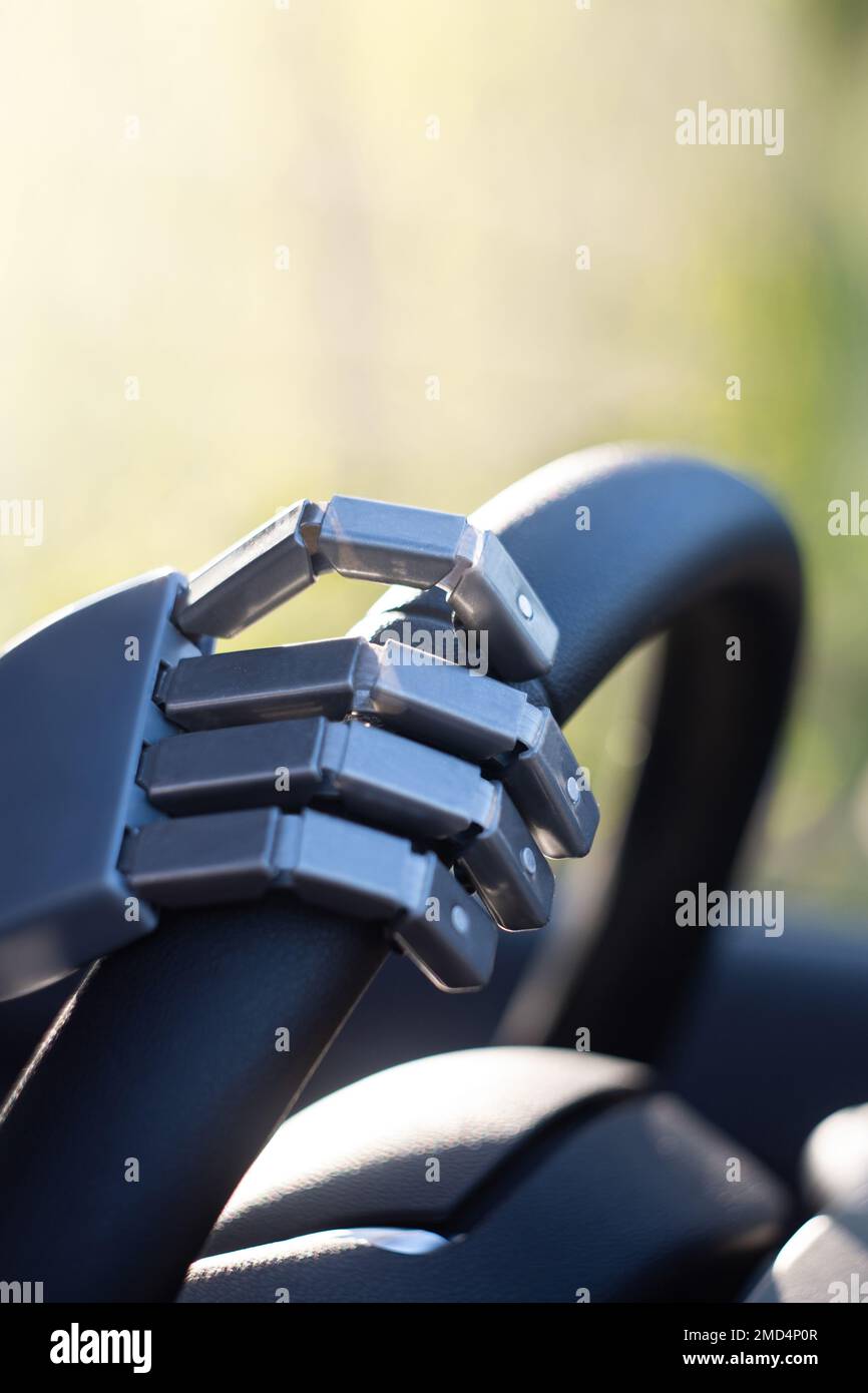 Robot arm on a steering wheel. Artificial intelligence drives a car. Autonomous vehicle concept. Stock Photo