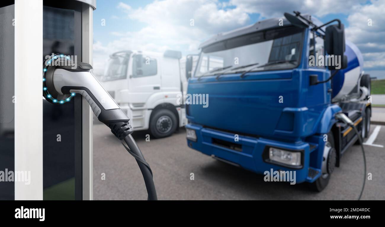 Electric vehicles charging station on a background of a trucks. Concept Stock Photo