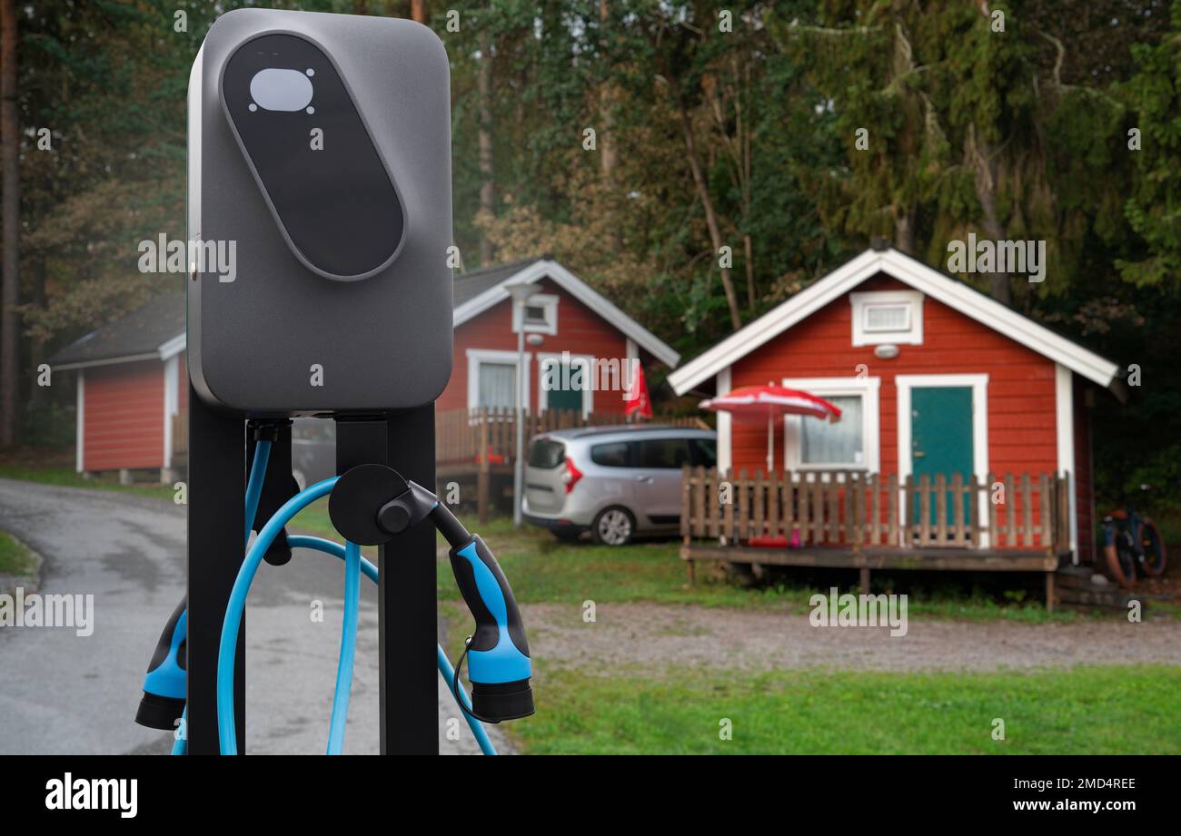 Close-up of a charging station for electric car against the backdrop of a campsite Stock Photo