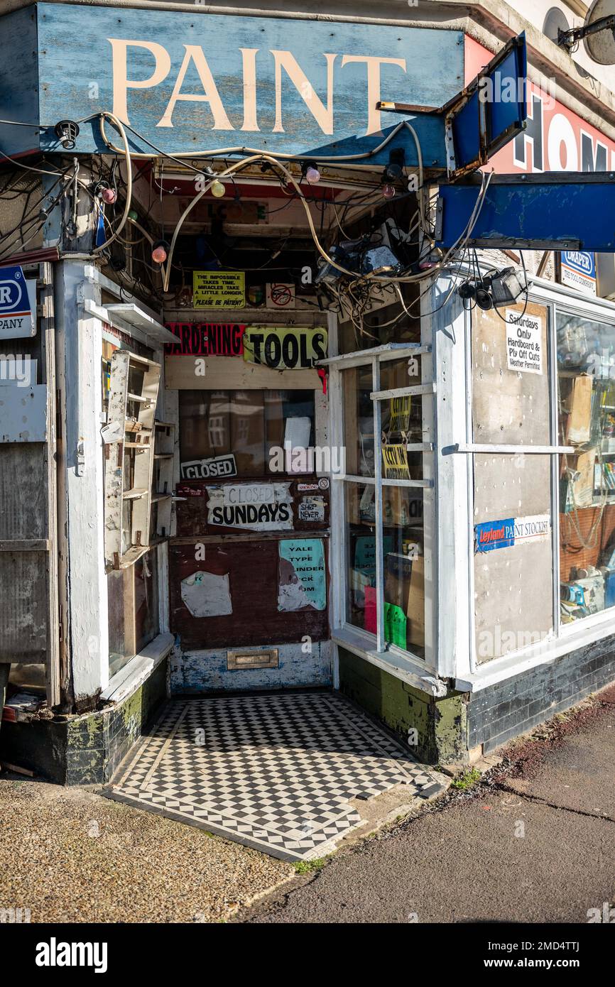 Old hardware shop window displaying entrance, unaltered for decades at