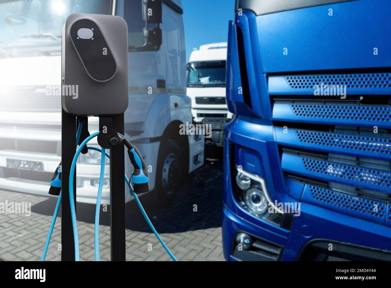 Electric vehicles charging station on a background of a trucks. Concept Stock Photo