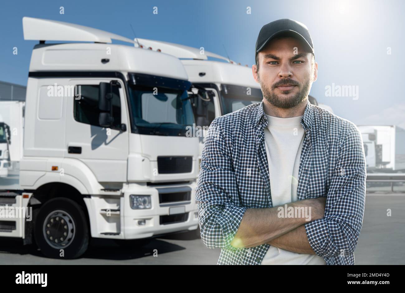Truck driver standing in front of trucks Stock Photo Alamy