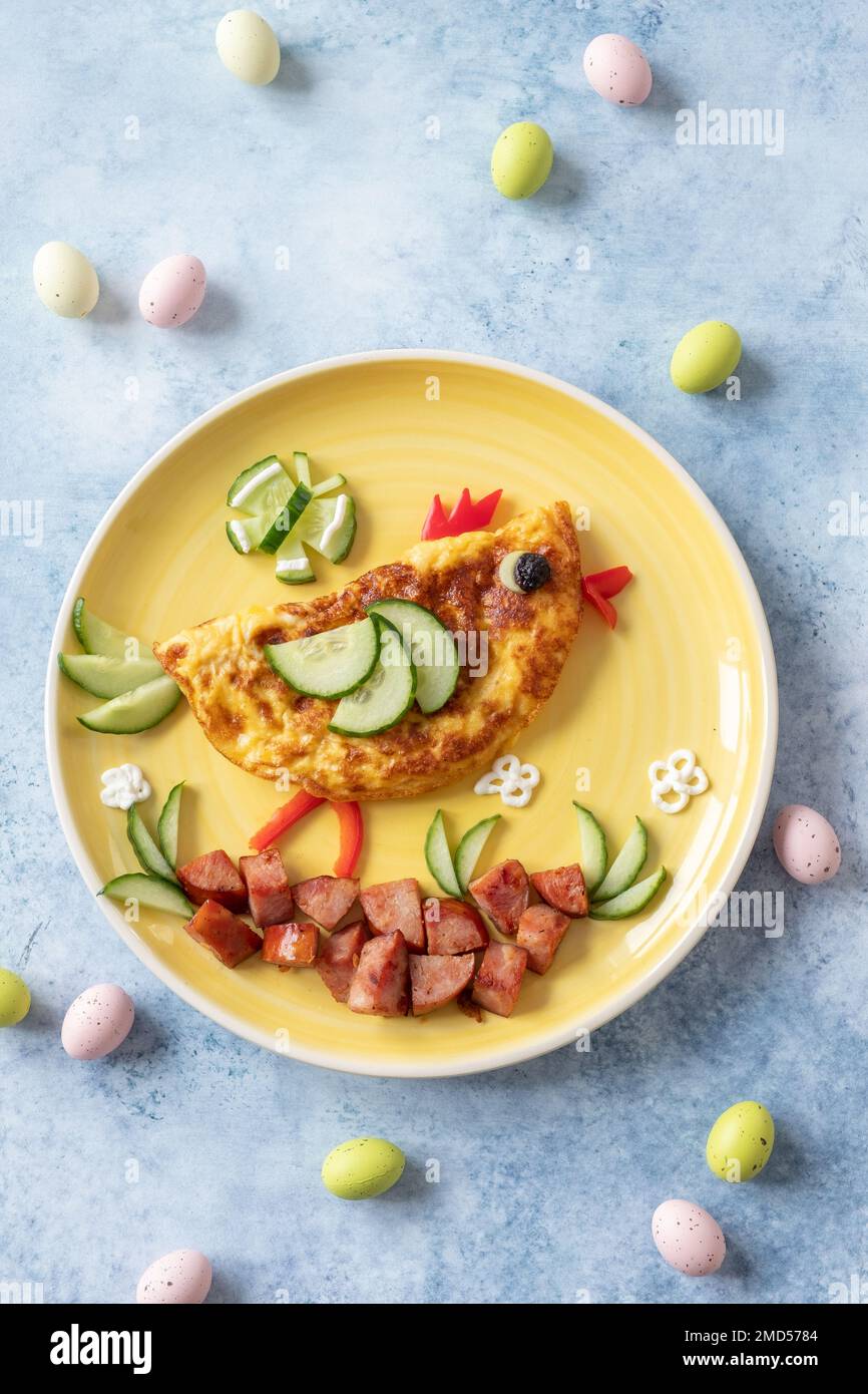 Funny chick egg omelette with ham vegetables for kids breakfast Stock Photo