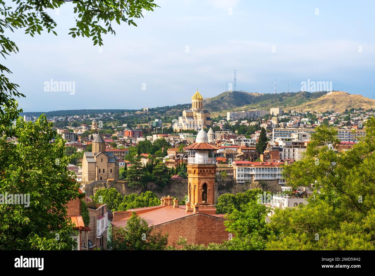 Tbilisi old town with Jumah Mosque in sulfur baths district, Metekhi Church on bank of river Kura and Sameba Cathedral, Georgia. Popular tourist Stock Photo