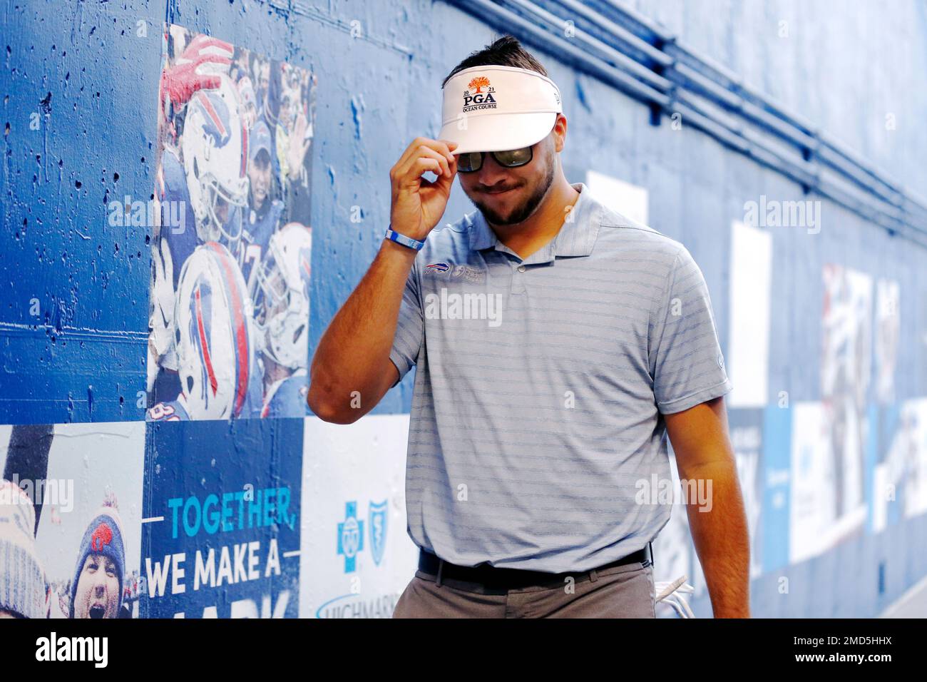 Buffalo Bills quarterback Josh Allen tips his visor as he wears