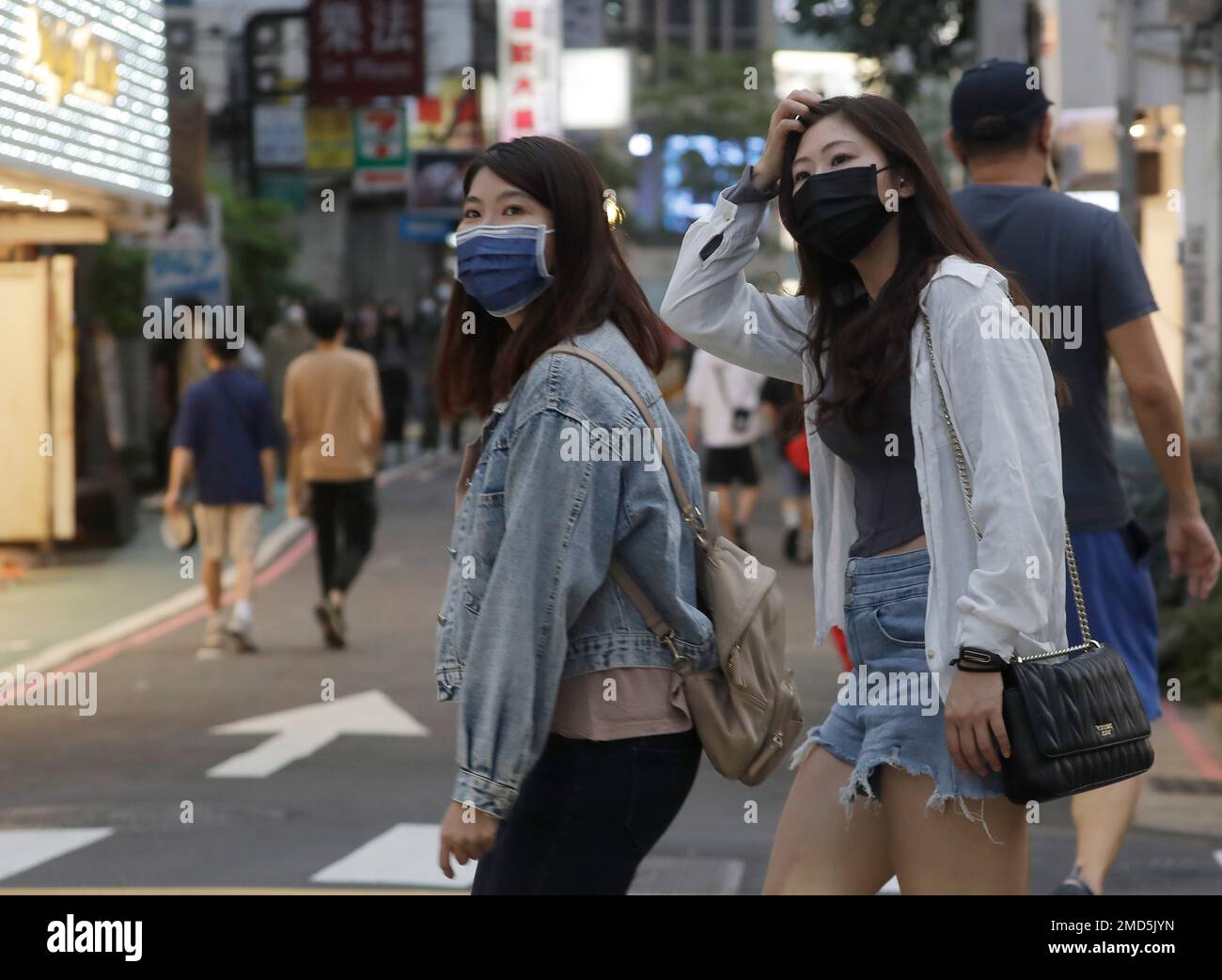 People wear face masks to protect against the spread of the coronavirus