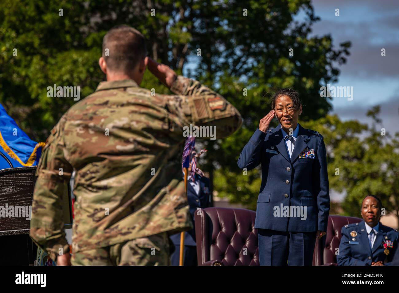 U.S. Air Force Col. Keegan Lyons, left, Defense Health Agency Sacramento Market deputy director and 60th Medical Group deputy commander, salutes Col. Melissa Dooley, DHA Sacramento Market director and 60th MDG commander, during the DHA Sacramento Market change of directorship and the 60th Medical Group change of command ceremony at David Grant USAF Medical Center, Travis Air Force Base, California, July 13, 2022. The change of command ceremony is rooted in military history, dating back to the 18th century, where the command flag is passed to the individual assuming command in the presence of t Stock Photo