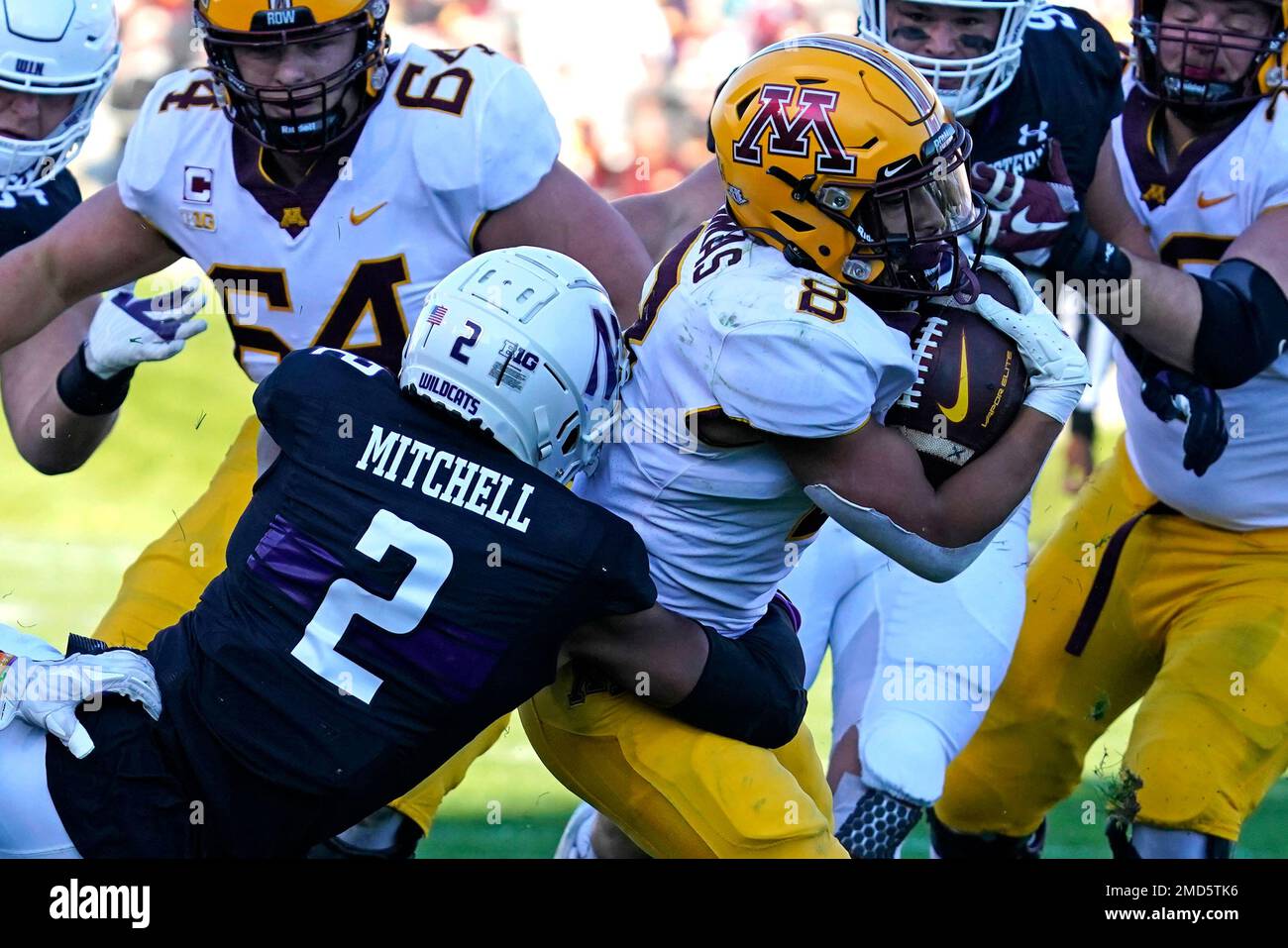 Minnesota running back Ky Thomas (8) is tackled by Northwestern