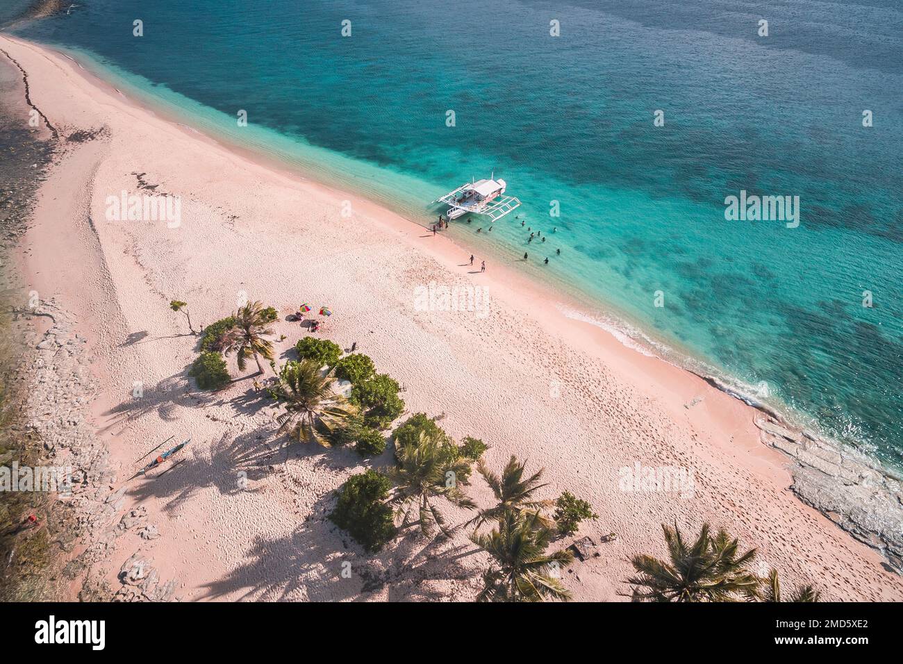 An aerial view of a beautiful white-sand beach and crystal-clear waters of Hagonoy Island Beach in San Agustin, Philippines Stock Photo