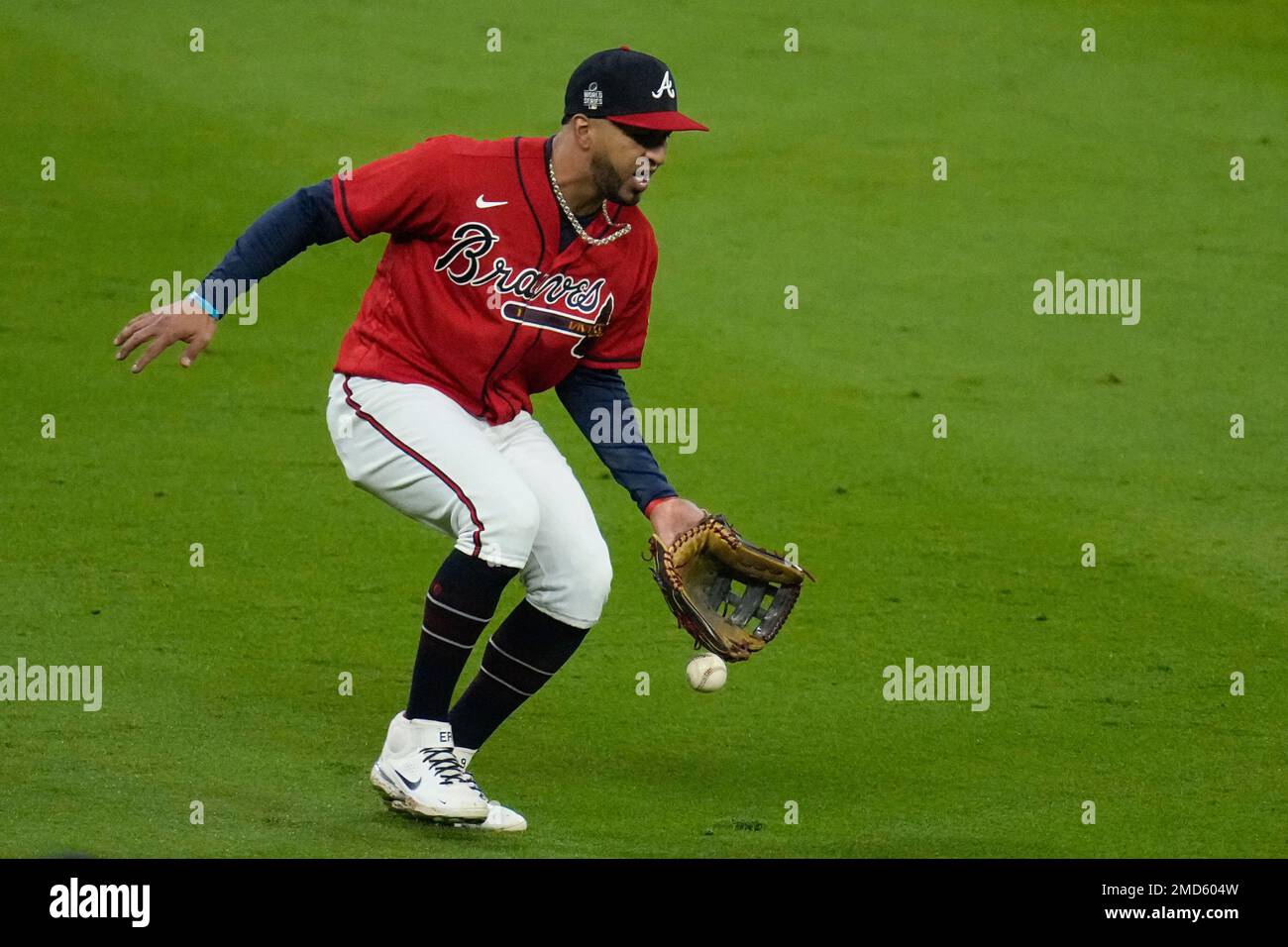 Atlanta Braves left fielder Eddie Rosario can't get a glove on a fly ball  hit by Houston Astros' Aledmys Diaz during the eighth inning in Game 3 of  baseball's World Series between