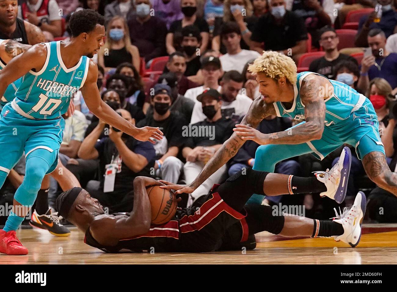 Charlotte Hornets guards Kelly Oubre Jr., left, and Isaiah Thomas, center,  vie for a rebound with New York Knicks guard Quentin Grimes, right, during  the first half of an NBA basketball game