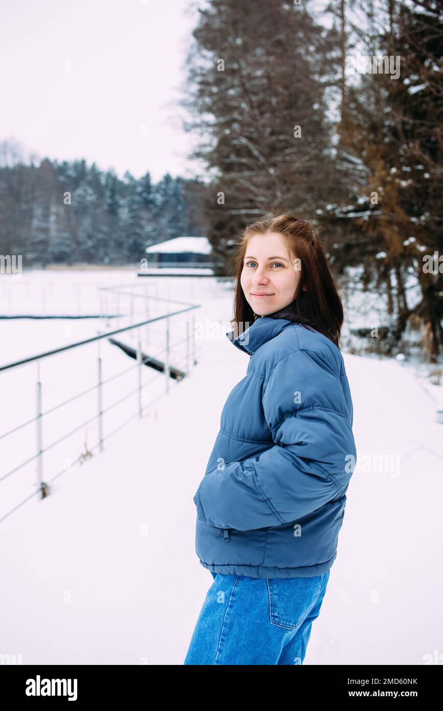 portrait of woman in winter clothes on the nature. There is a lot