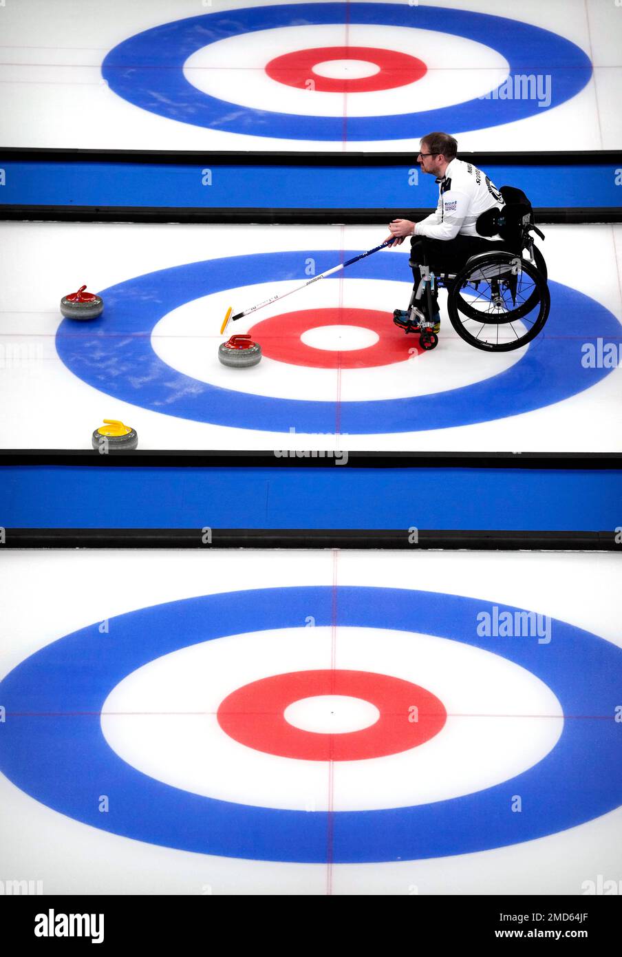 Hugh Nibloe of Scotland helps his team line up a throw during their semifinal match against Sweden at the World Wheelchair Curling Championship, a test event for the 2022 Winter Olympics, held