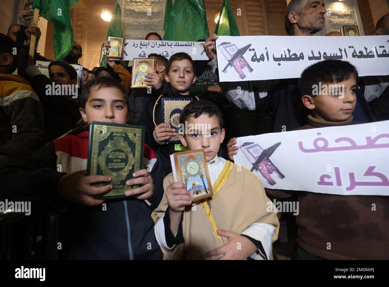 Rafah, Gaza. 22nd Jan, 2023. Palestinians protesters hold up a copy of the Quran during a protest against the burning of the Quran in Sweden, in Rafah in Southern Gaza on Sunday January 22, 2023. Surrounded by police, Rasmus Paludan, a Danish-Swedish politician, lawyer and far-right extremist, set fire to the holy book with a lighter following a long diatribe of almost an hour, in which he attacked Islam and immigration in Sweden. Several Arab countries - including Saudi Arabia, Jordan, Kuwait and Turkey-also denounced the Quran-burning. Photo by Ismael Mohamad/UPI Credit: UPI/Alamy Live News Stock Photo