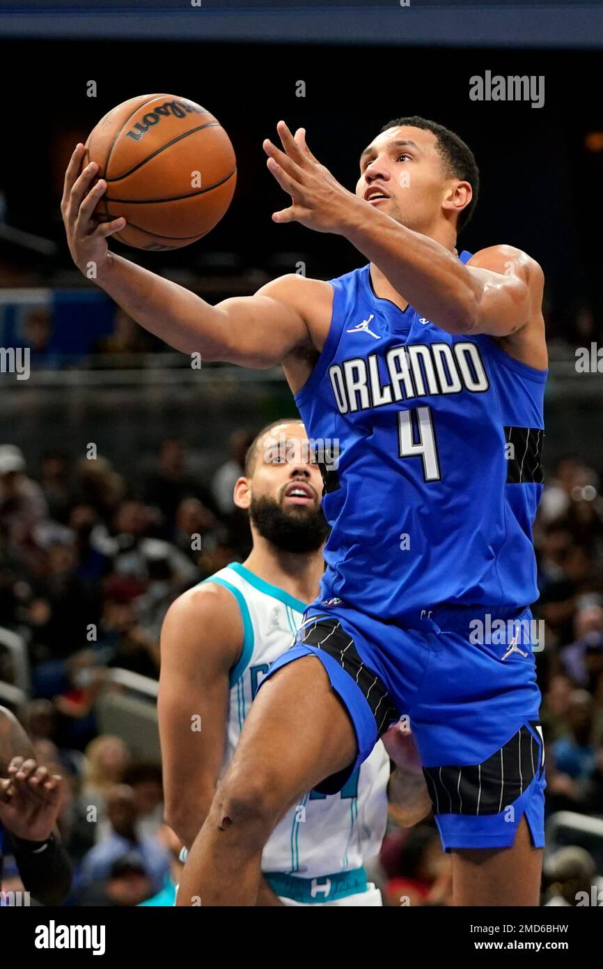 Orlando Magic's Jalen Suggs (4) takes a shot over Cleveland Cavaliers' Dean  Wade, left, during the