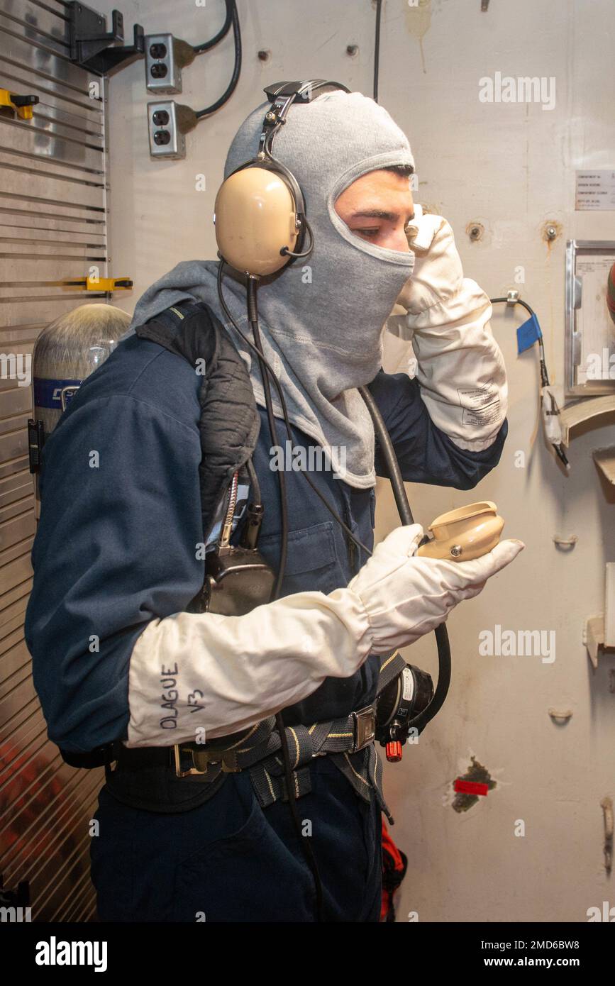 U.S. Navy Airman Pedro Olague, from Los Angeles, assigned to the aircraft carrier USS John C. Stennis (CVN 74), operates a sound powered telephone during a damage control drill aboard the ship, July 13, 2022, in Newport News, Virginia. The John C. Stennis is in Newport News Shipyard working alongside NNS, NAVSEA and contractors conducting Refueling and Complex Overhaul as part of the mission to deliver the warship back in the fight, on time and on budget, to resume its duty of defending the United States. Stock Photo