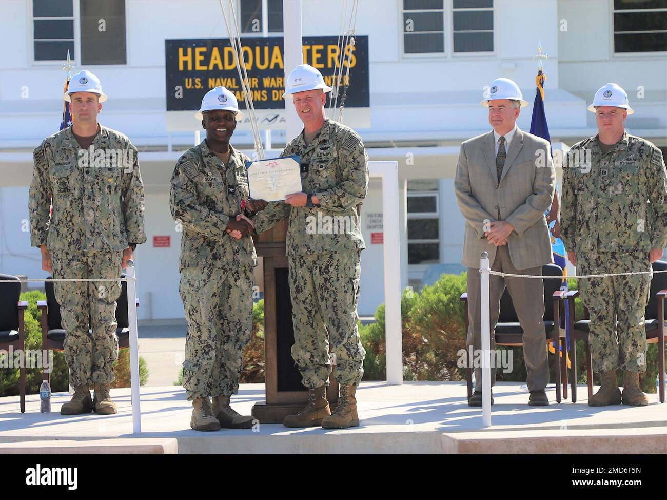 (CHINA LAKE) – Rear Adm. Dean VanderLey, NAVFAC Pacific commander presents Capt. Laurie Scott with the Legion of Merit military award for his outstanding service as both NAVFAC Southwest Operations Officer and OICC China Lake’s commanding officer on July 13. (L-R, Cmdr. Ben Wainwright, incoming OICC China Lake commanding officer, Capt. Laurie Scott departing OICC China Lake commanding officer, Rear Adm. Dean VanderLey, NAVFAC Pacific commander, Mr. Brad Harlow, NAWCWD Deputy Technical Director and Lt. David Brainard, NAWS China Lake command Chaplain) Stock Photo