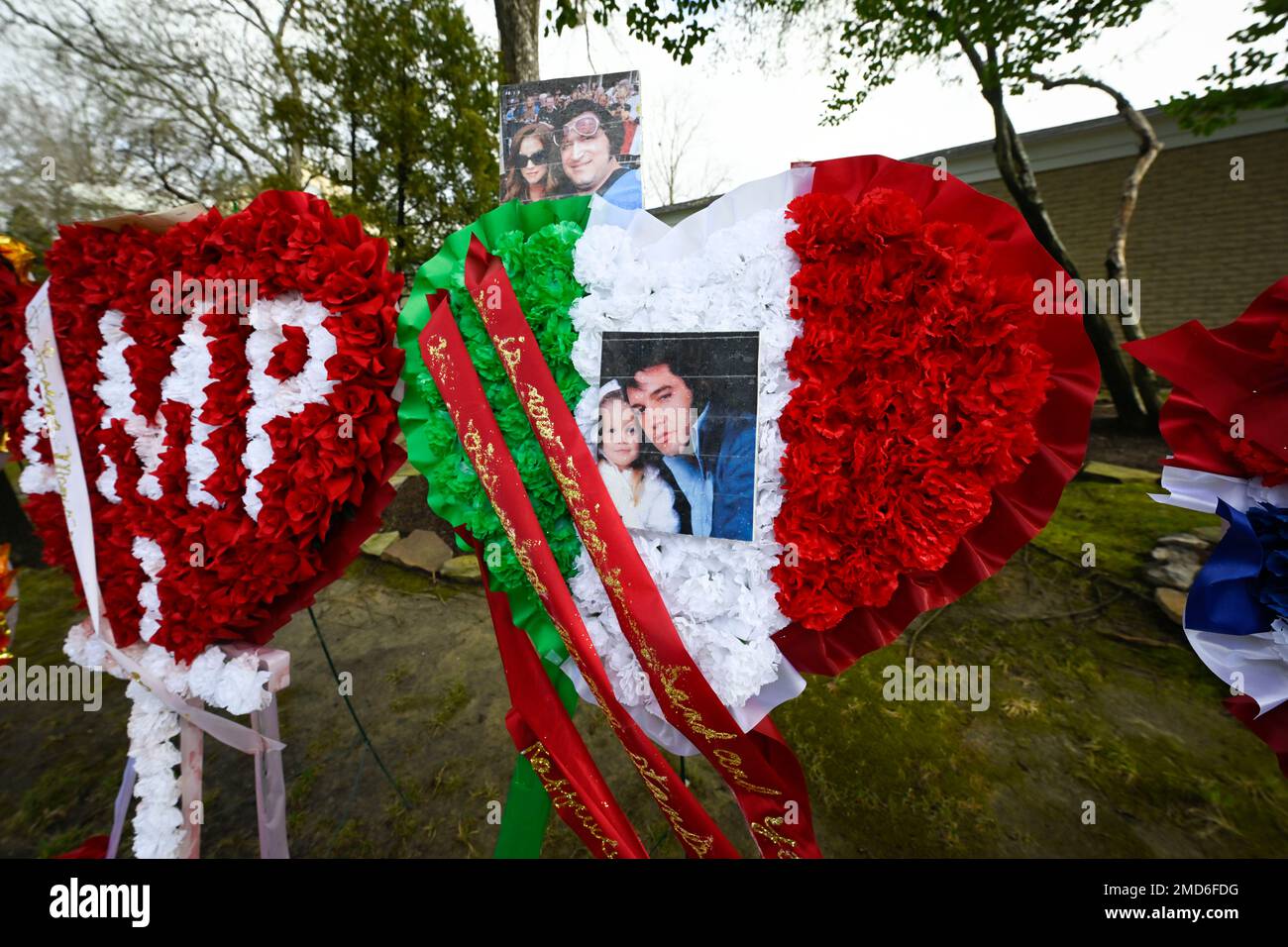 Wreaths line a path to the grave site after a memorial service for Lisa