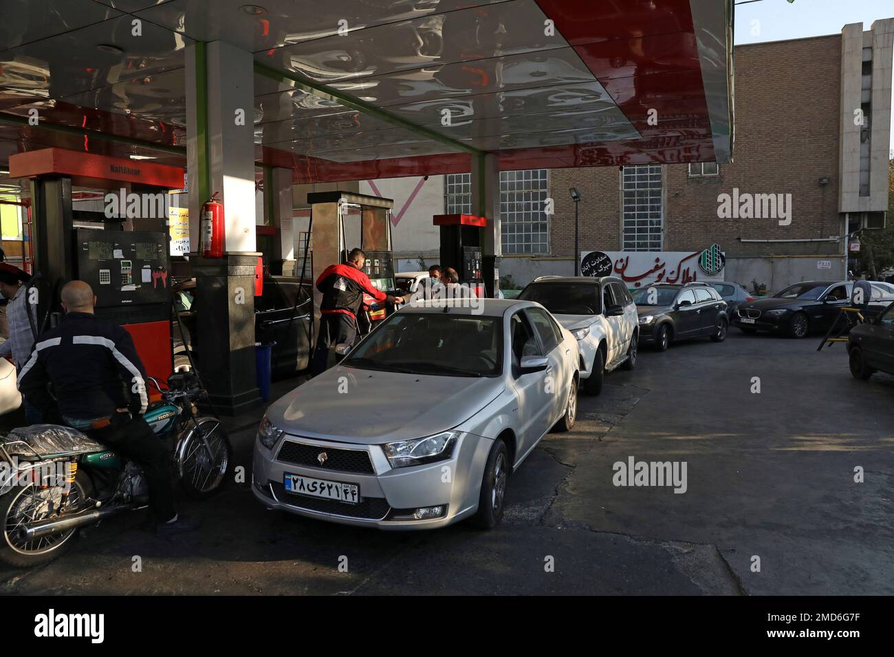 People fill their cars at a gas station in Tehran, Iran Wednesday, Oct