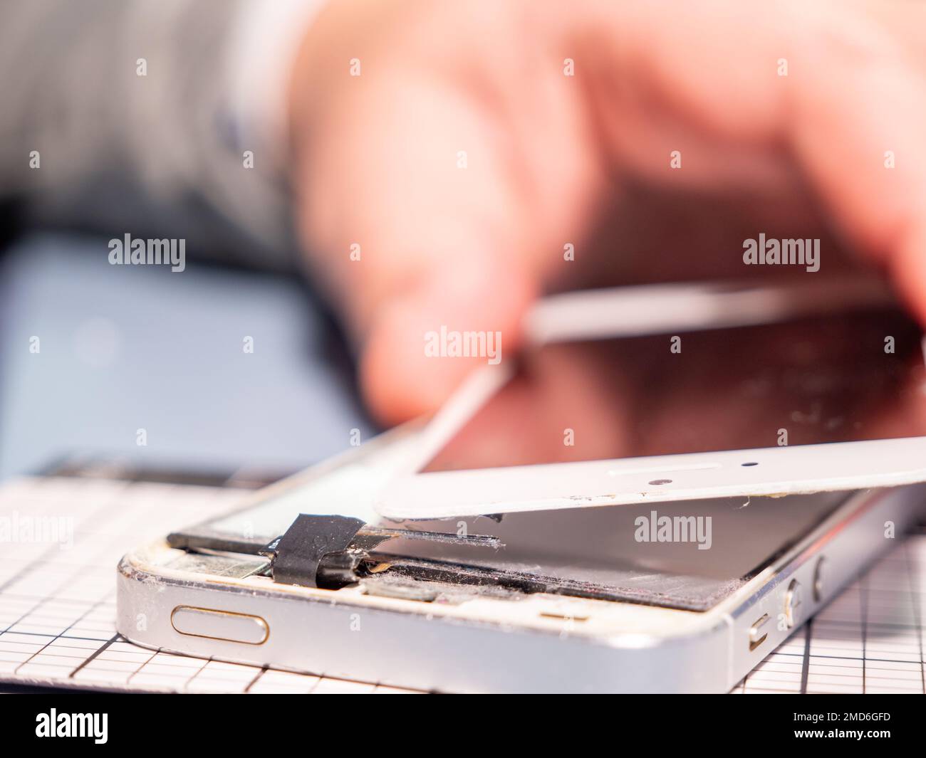 A technician repairs a smartphone in a laboratory with copy space. concept of computer hardware