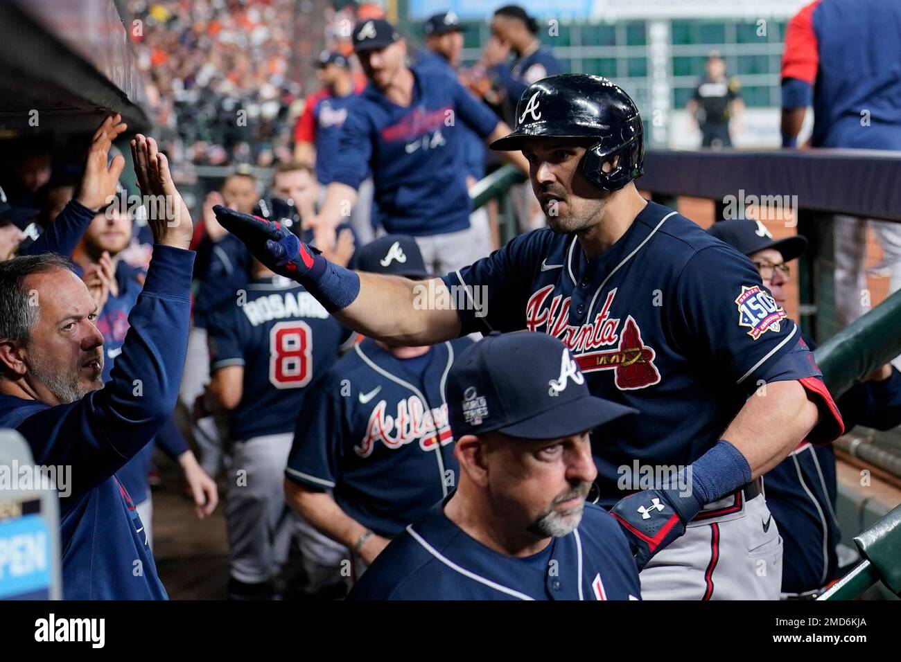 Atlanta Braves' Adam Duvall, right, celebrates his two-run home run in the  dugout during the third inning of Game 1 in baseball's World Series between  the Houston Astros and the Atlanta Braves
