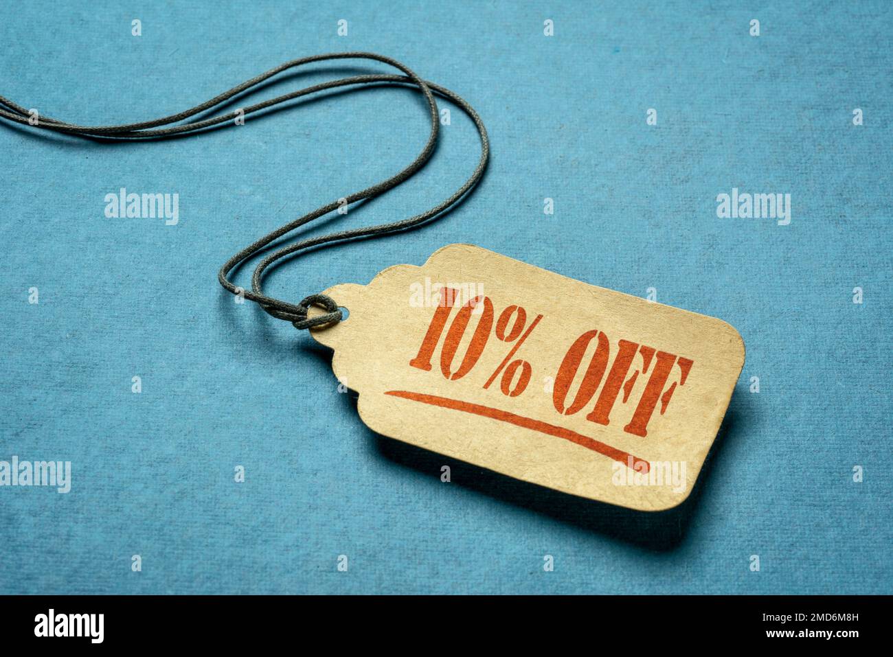 10 percent off - a paper price tag against blue background, sale, discount and shopping concept Stock Photo