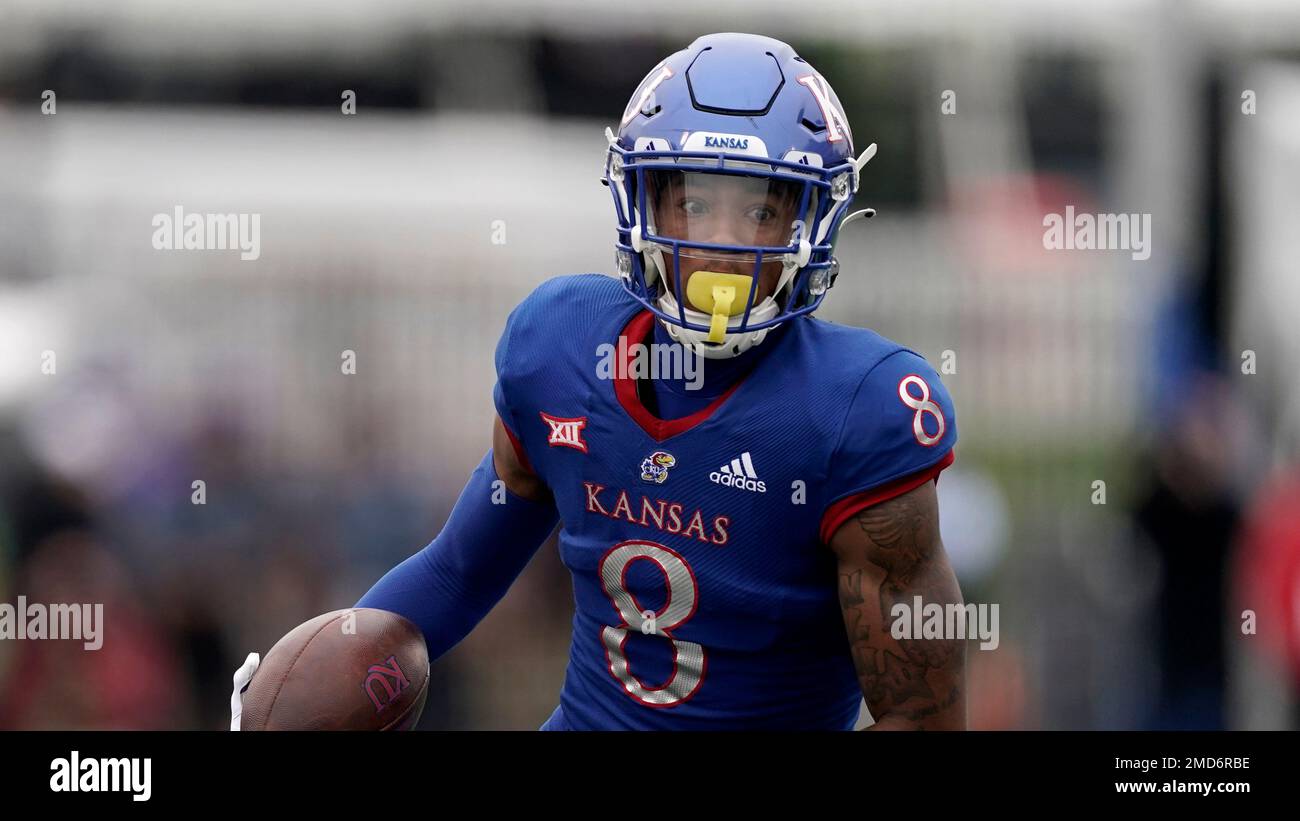 Kansas wide receiver Kwamie Lassiter II (83) catches a touchdown pass while  covered by Oklahoma State safety Jarrick Bernard (24) during the first half  of an NCAA college football game in Lawrence