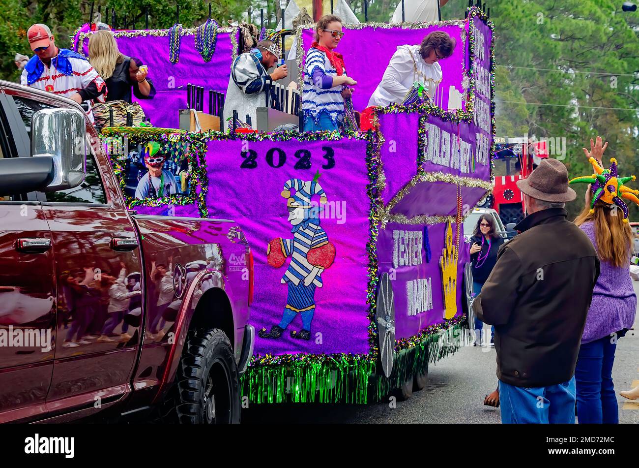 Members of Krewe de la Dauphine ride a Mardi Gras float during the Krewe de la Dauphine Mardi Gras parade, Jan. 21, 2023, in Dauphin Island, Alabama. Stock Photo