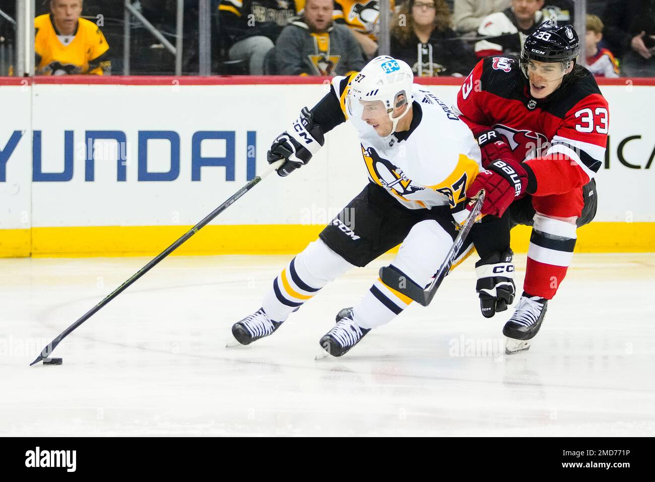 Pittsburgh Penguins' Sidney Crosby (87) drives past New Jersey Devils' Ryan  Graves (33) during the first