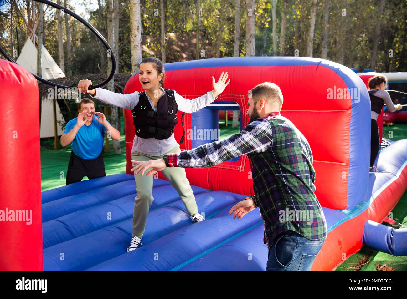 People passing obstacles on inflatable arena at amusement park Stock ...