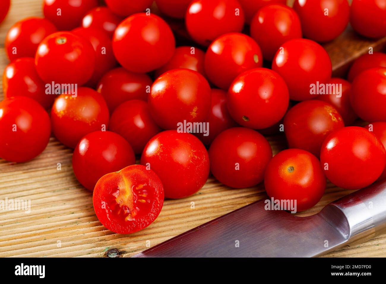 Fresh organic cherry tomatoes on wooden table Stock Photo - Alamy
