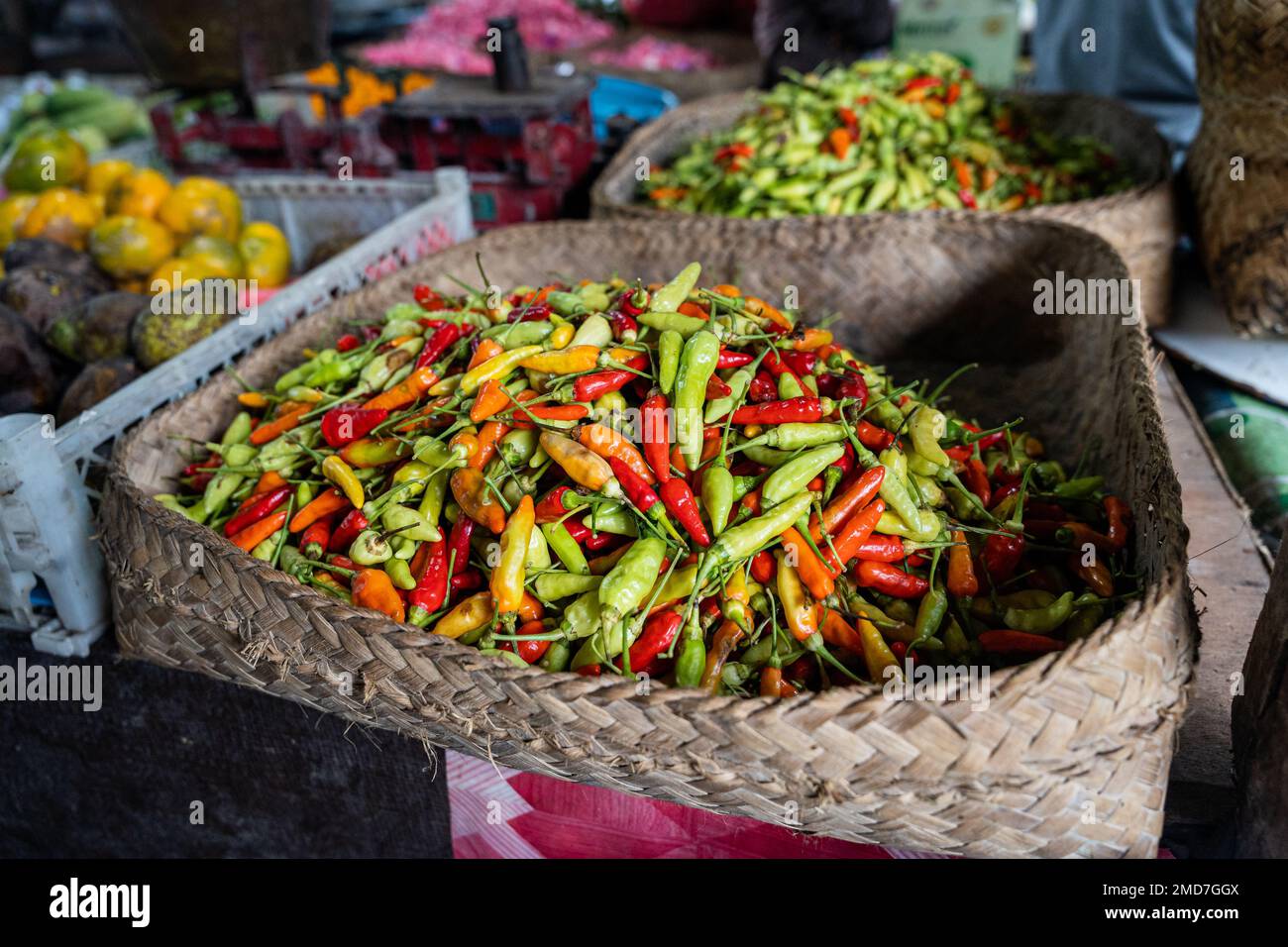 A basket full of fresh Indonesian chili peppers, also called rawit or bird's eye chili, horizontal Stock Photo