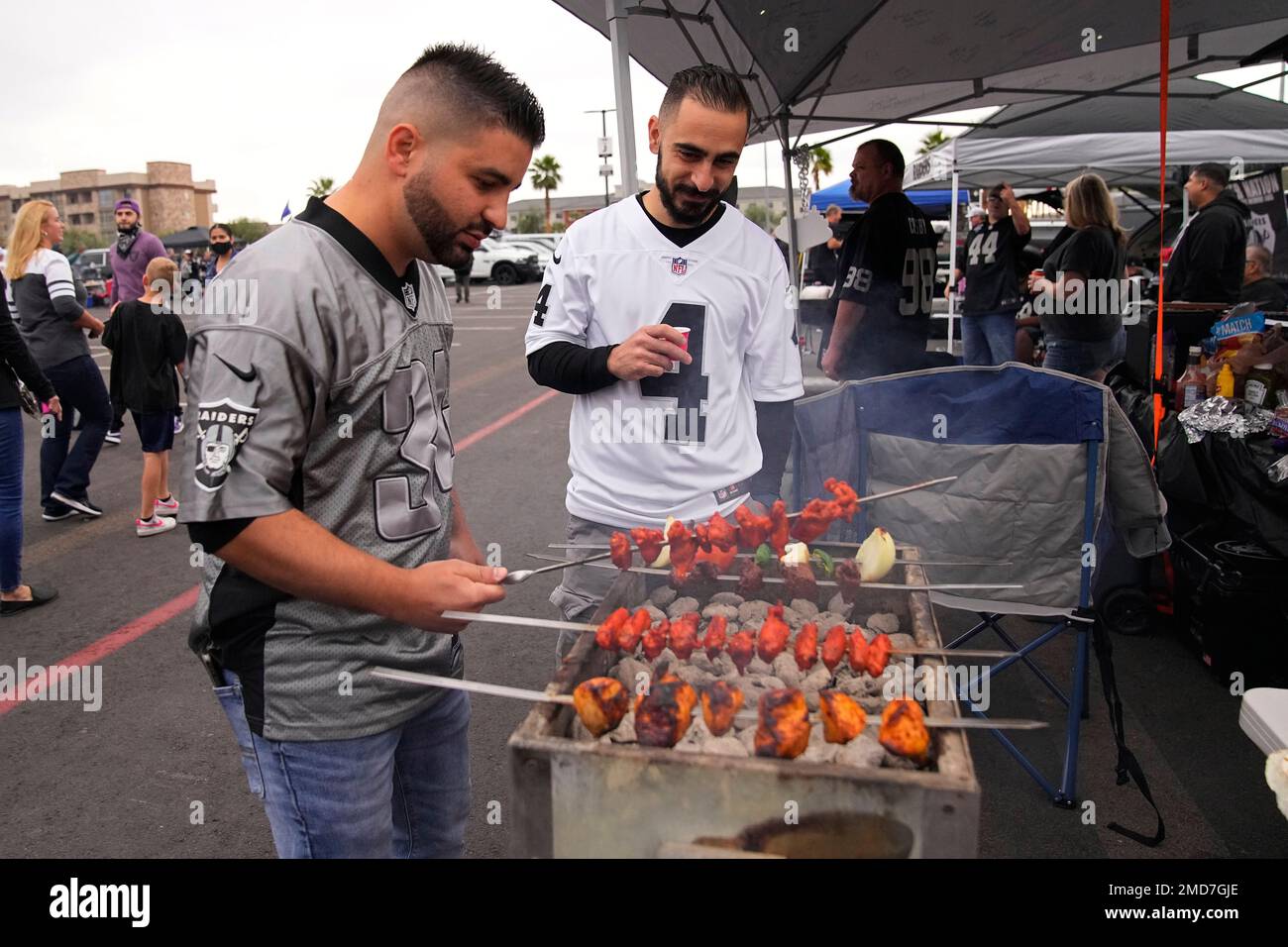 Arsham Hayrikian, left, and Oshin Baghram cook while tailgating before ...