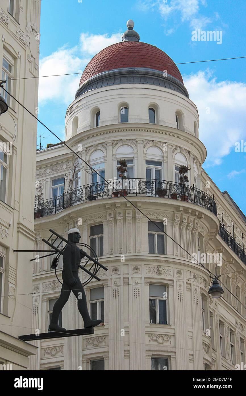 Vienna, Austria - 17 April 2012: Metal statue of the chimney sweeper on a street corner, selective focus. Symbol of flue cleaner Stock Photo