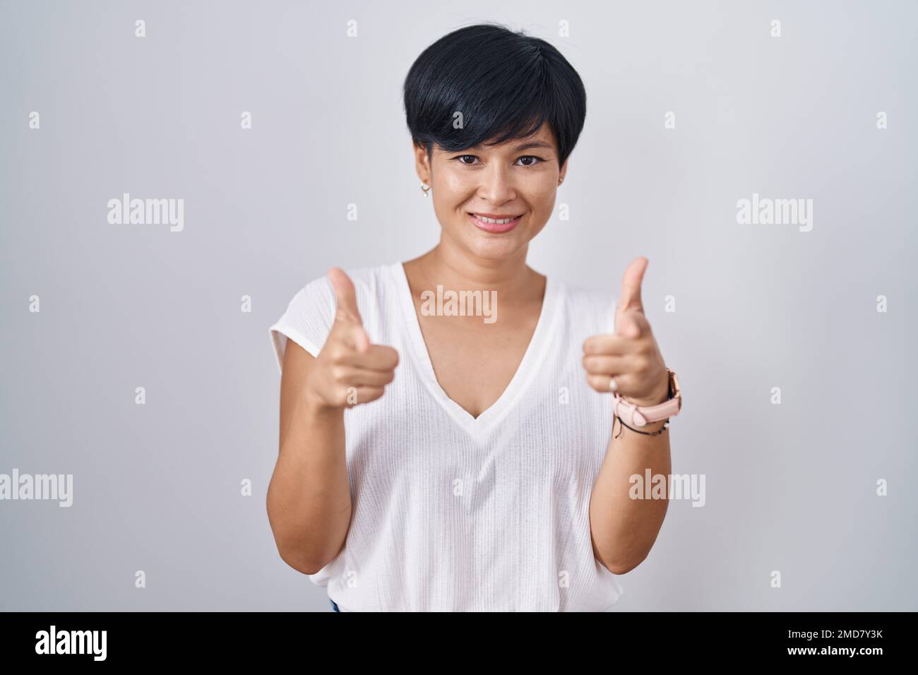 Young Asian Woman With Short Hair Standing Over Isolated Background Pointing Fingers To Camera 9303