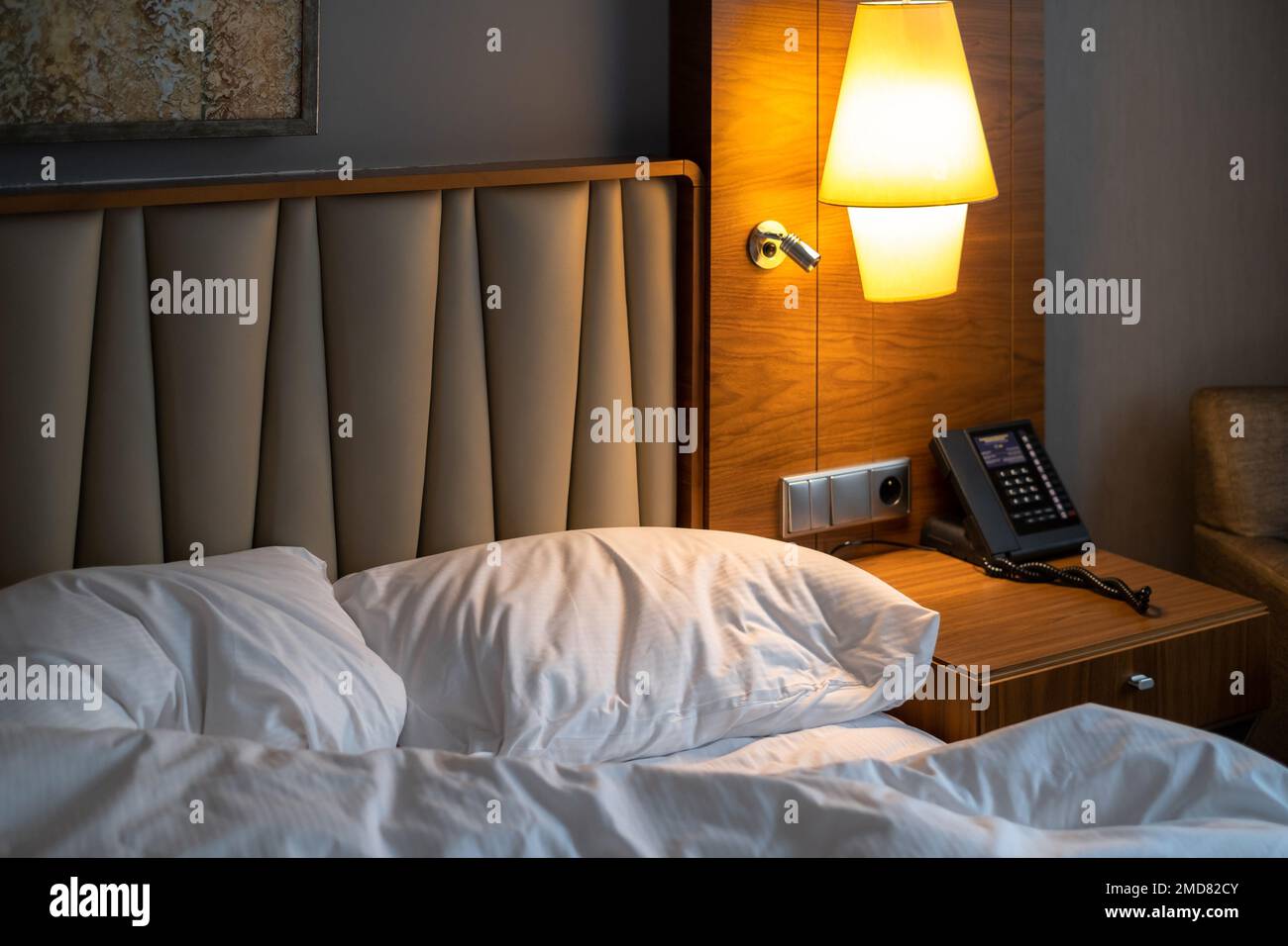 Cozy and inviting hotel room with a comfortable bed, clock and modern decor perfect for a