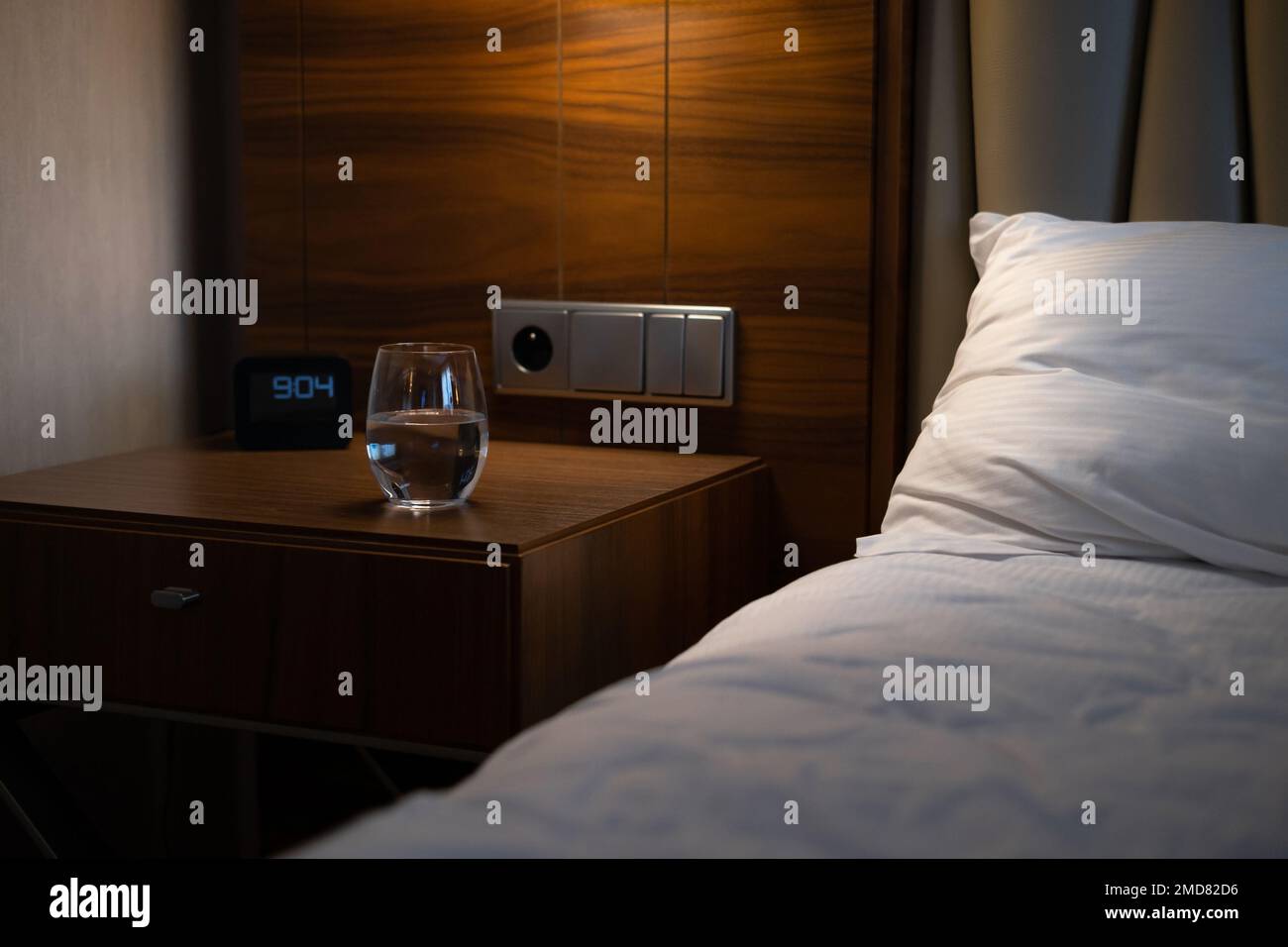 Cozy and inviting hotel room with a comfortable bed, clock and modern decor perfect for a
