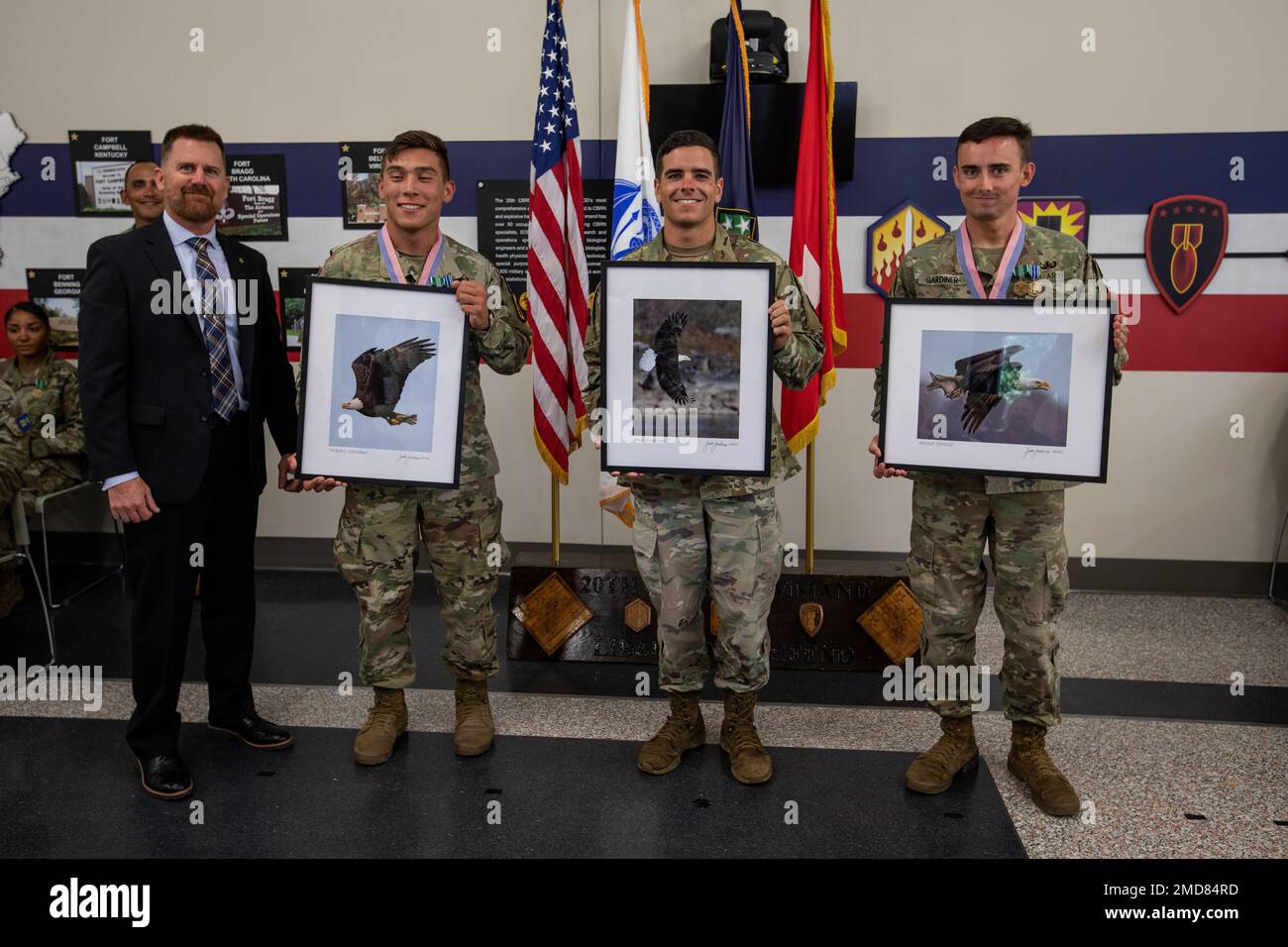 The winners from the 20th Chemical, Biological, Radiological, Nuclear, and Explosives (CBRNE) Best Warrior Competition, Best NCO is Sgt. Micah Miller, an explosive ordnance technician with 52nd Ordnance Group, Best Soldier is Spc. Logan Gardiner, an EOD tech with 52nd EOD, and Best Officer is Cpt. John Lintner with 48th Chemical Brigade, pose for a photo during the awards ceremony at Aberdeen Proving Ground, Maryland, July 14, 2022. The 20th CBRNE Command’s Best Squad Competition and Best Warrior Competition is a single event used to select the best Noncommissioned Officer of the Year and Sold Stock Photo