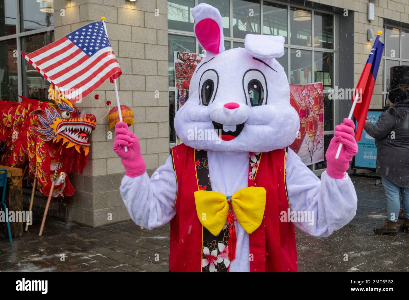 Detroit, Michigan, USA. 22nd Jan, 2023. The Michigan Taiwanese American Organization celebrates Lunar New Year with a parade, lion dance, and dragon dance at Valade Park. A woman in a rabbit costume holds American and Taiwanese flags. The new year is the Year of the Rabbit. Credit: Jim West/Alamy Live News Stock Photo