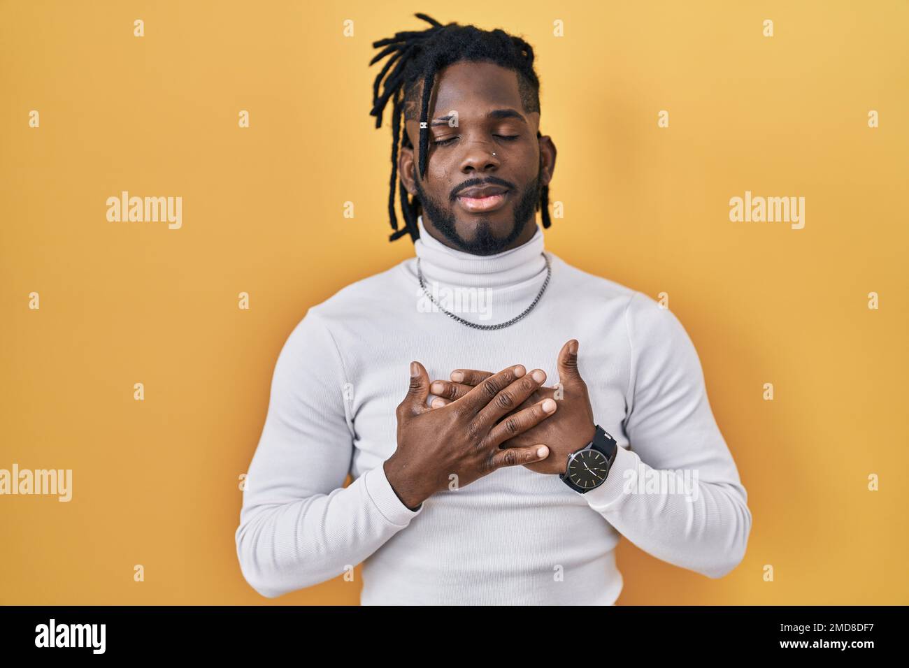 Dreadlocks Chest African man with dreadlocks wearing turtleneck sweater over yellow ...