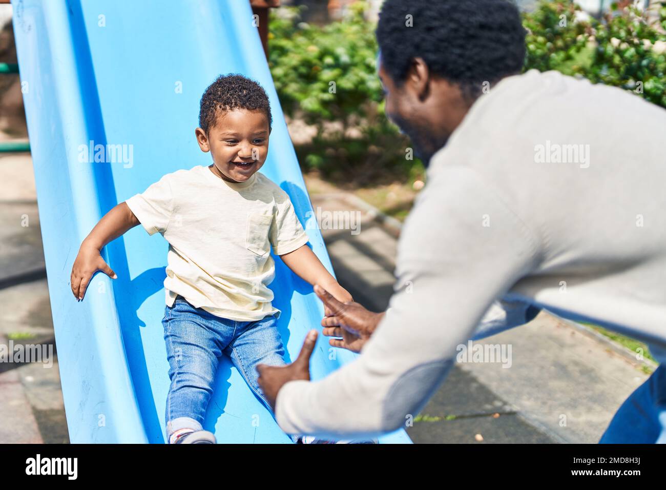 Playground slide man standing hi-res stock photography and images - Alamy