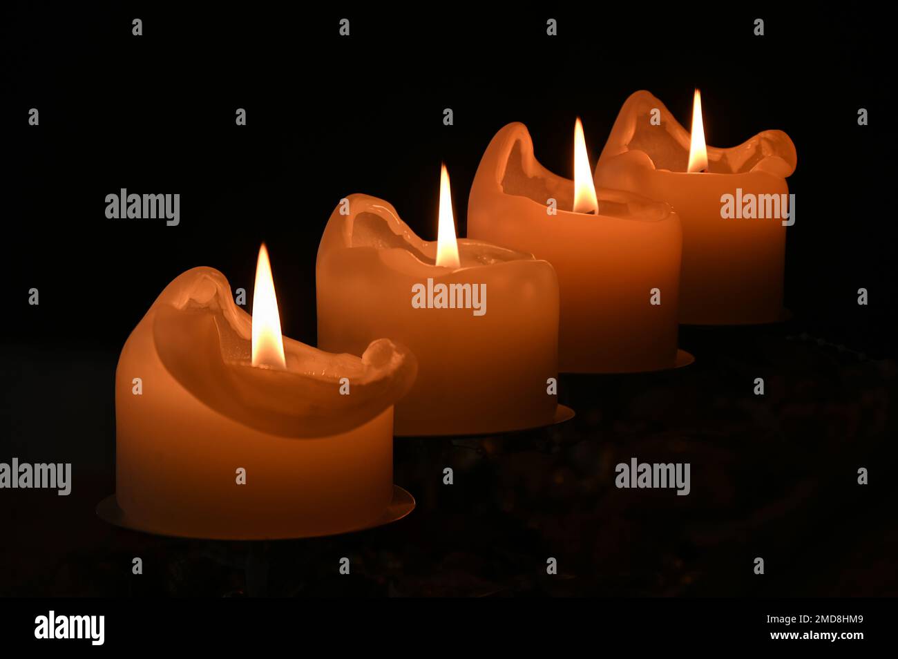 Four advent lit candles with focus on all four Stock Photo Alamy