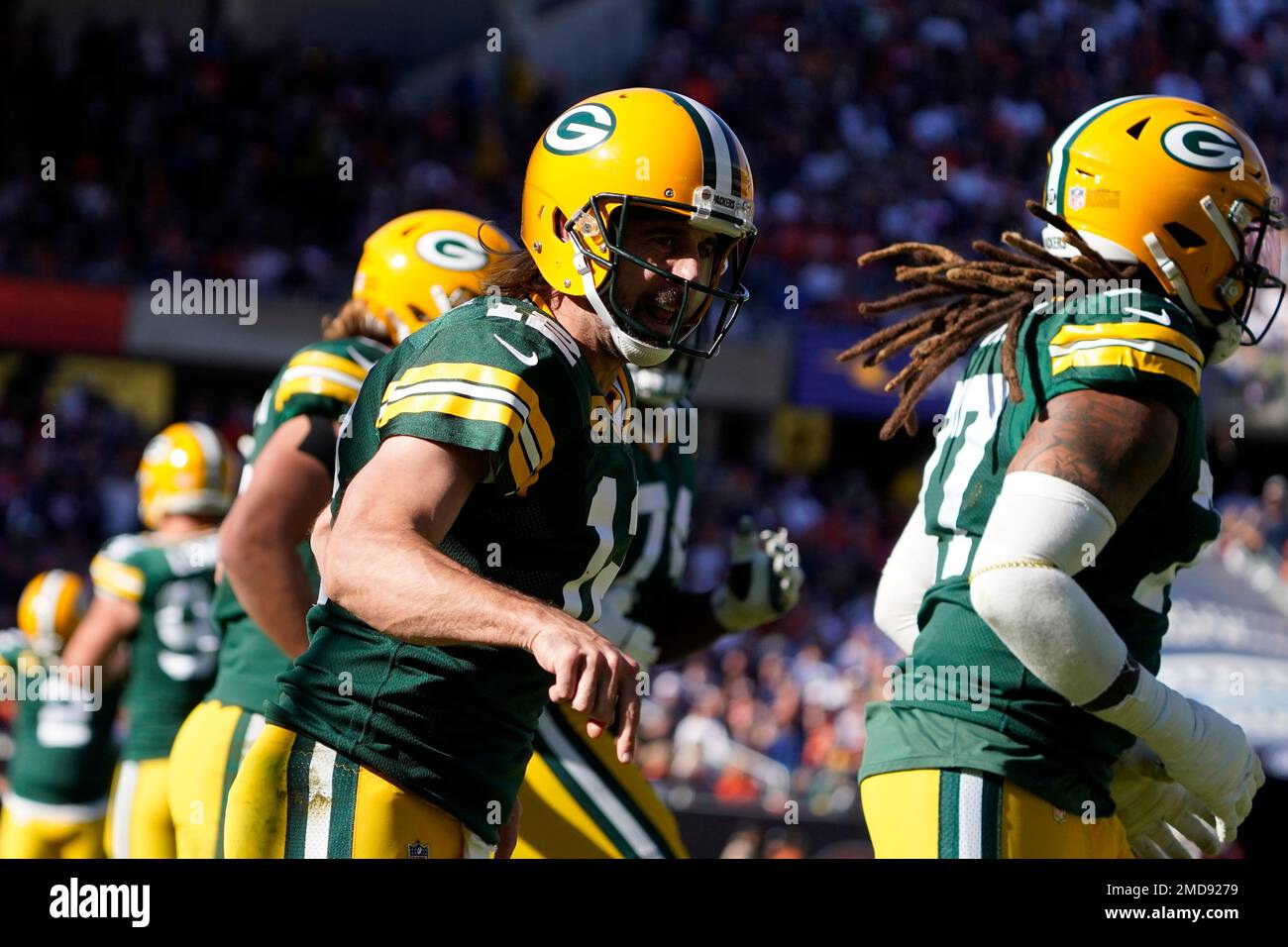 Green Bay Packers quarterback Aaron Rodgers (12) celebrates his rushing  touchdown against the Chicago Bears during