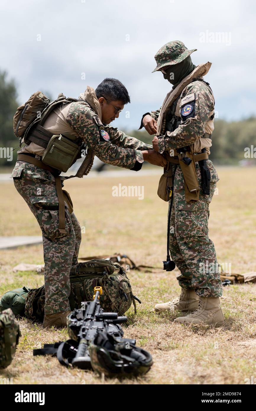 BELLOWS AIR FORCE FIELD, Hawaii (July 14, 2022) Malaysian Army  Paratroopers, assigned to 10th Brigade Paratrooper from the 18th Royal  Malaysian Regiment, Malaysian Army, conduct pre-flight safety equipment  checks at Bellows Air