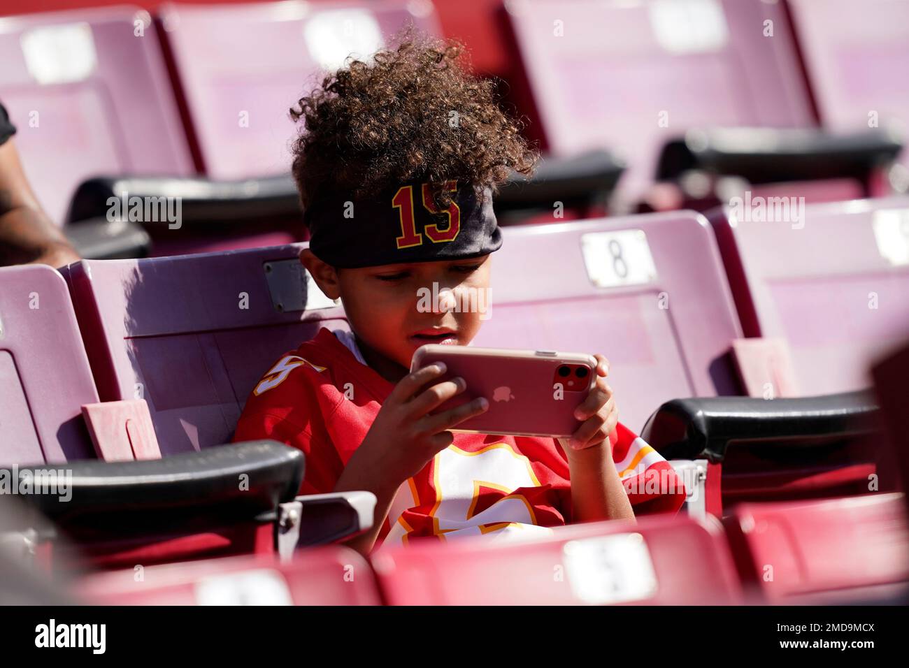 A Kansas City Chiefs fan wearing a head dress tries to get the attention of  a player before the Chiefs-Arizona Cardinals game at the University of  Phoenix Stadium in Glendale, December 7