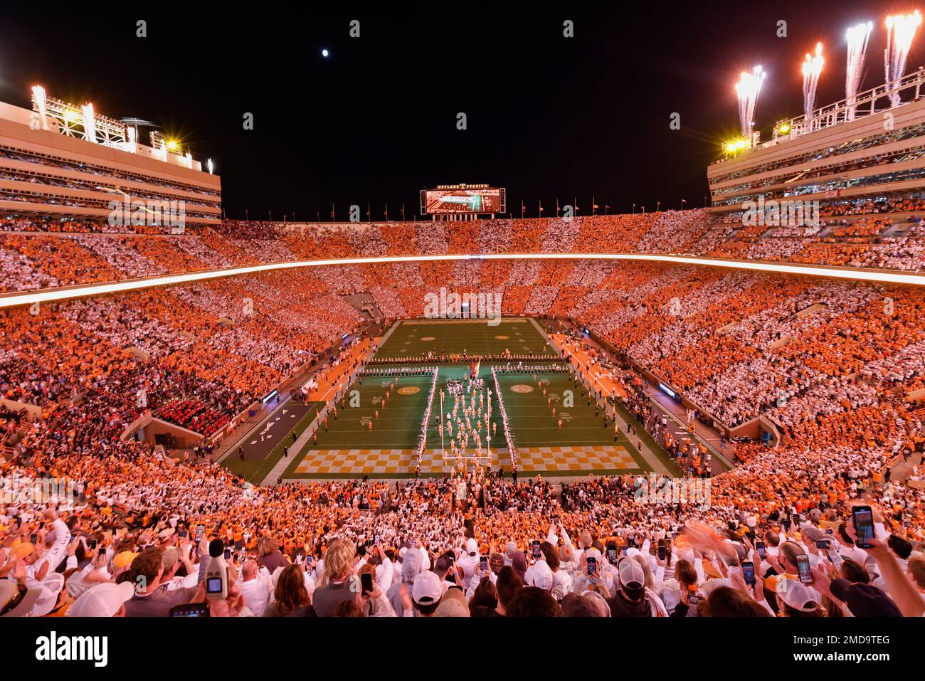 Fans dressed in orange and white form the checkerboard pattern in Neyland  Stadium as Tennessee players run through the \, image size:1300x957