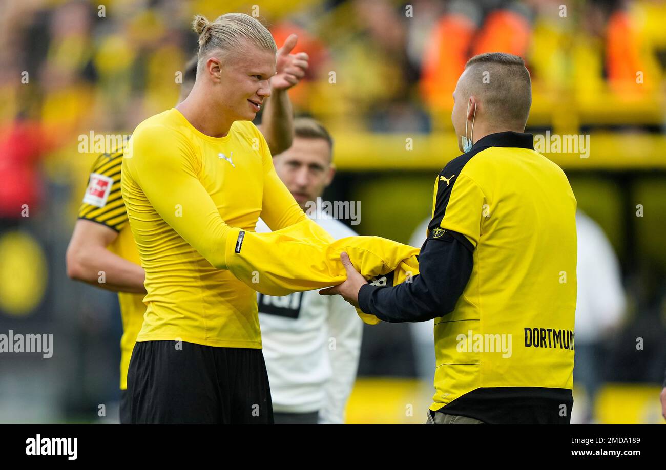 Dortmund s Erling Haaland gives his shirt to a supporter on the