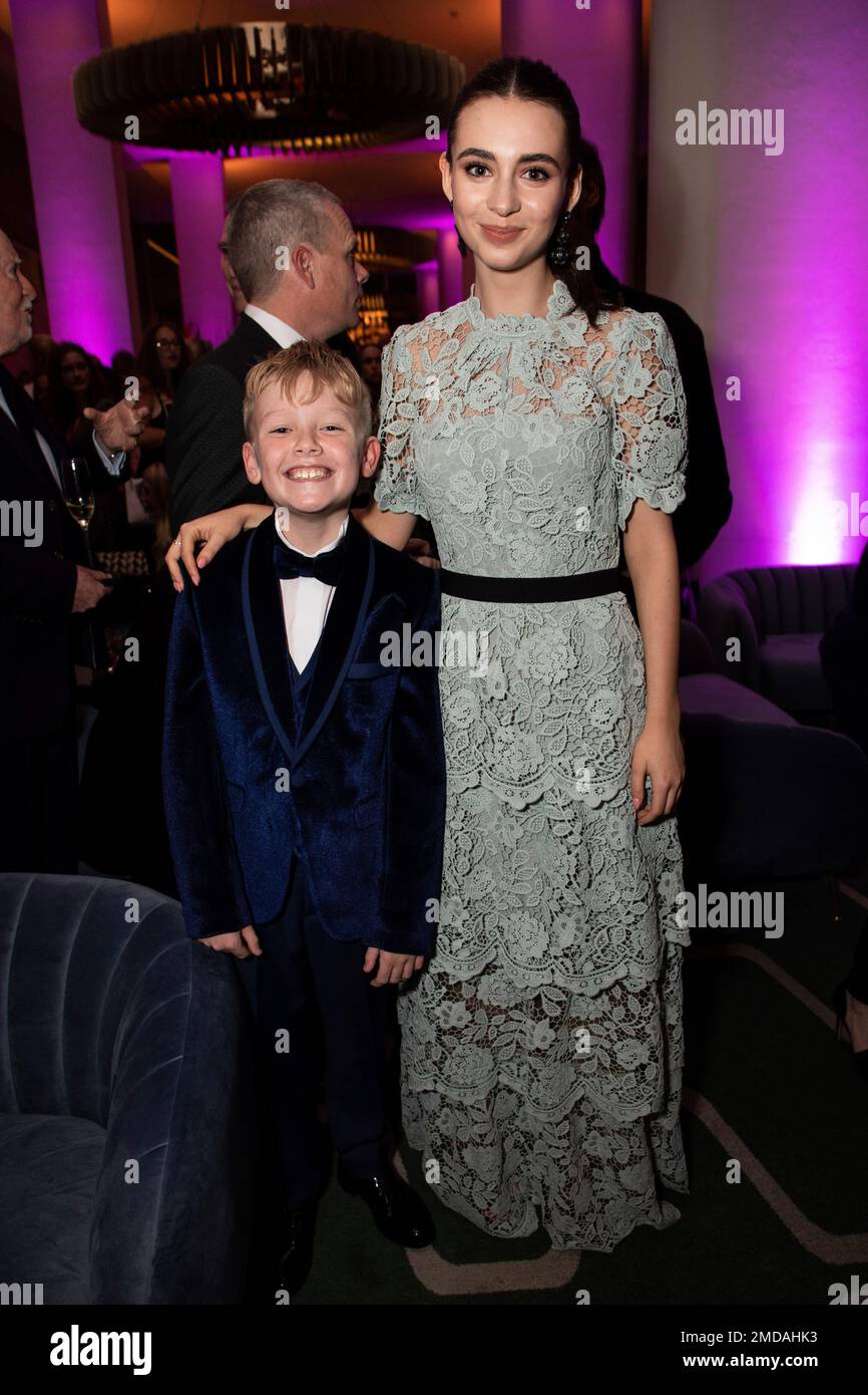Jude Hill, left, and Lara McDonnell pose for photographers at the party